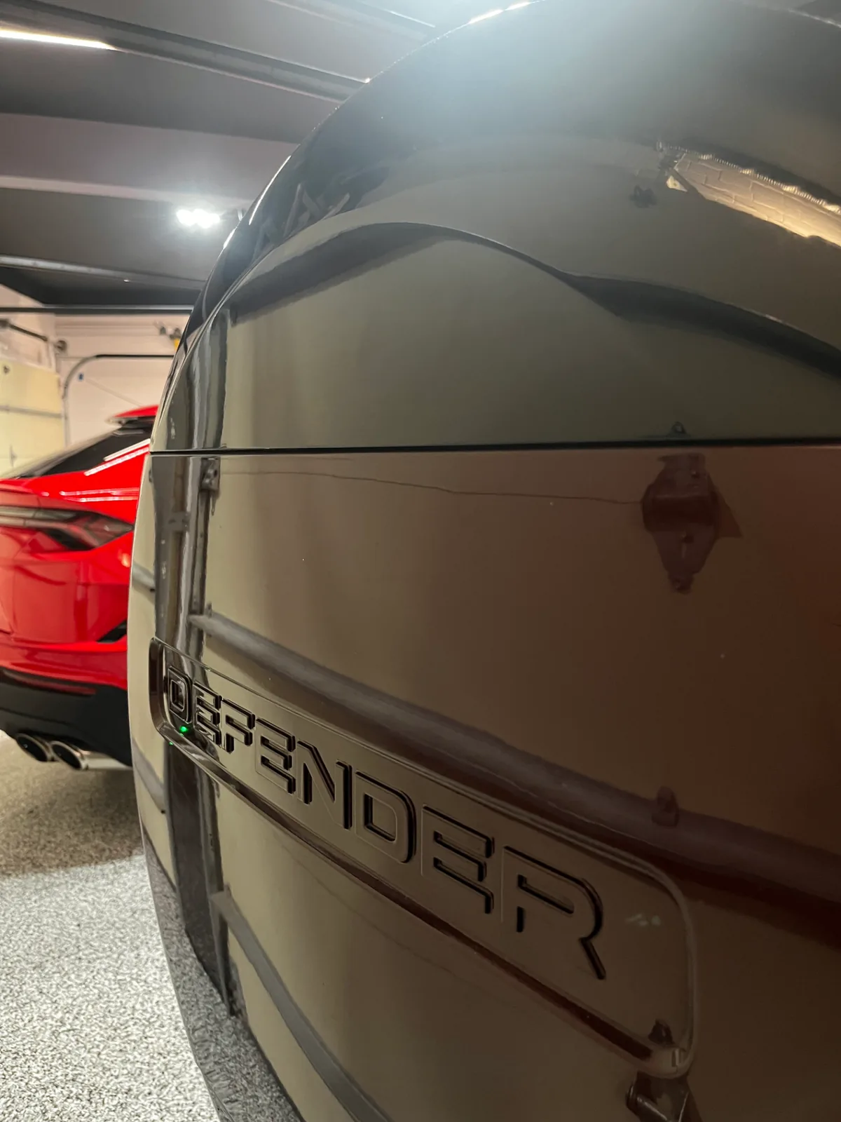 Glossy, freshly cleaned rear Defender badge on the same SUV after Bluefin detailing
