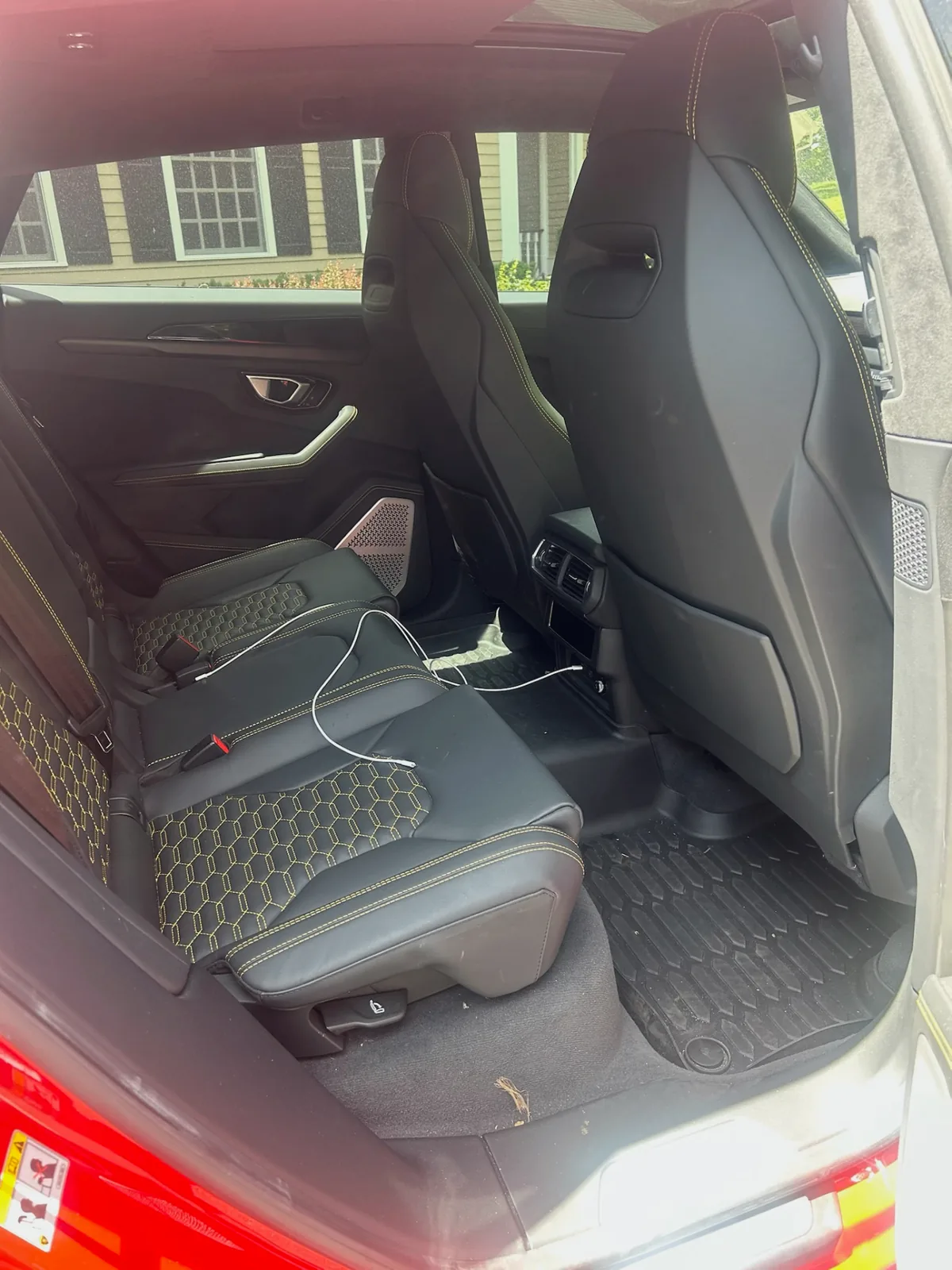 Cluttered rear interior with charging cables before Bluefin detailing