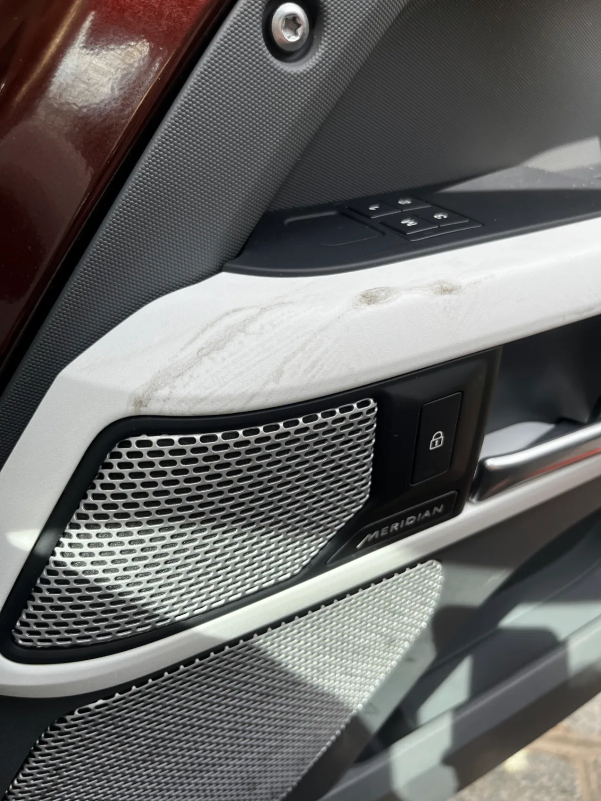 Interior door panel with soiled white armrest before Bluefin detailing