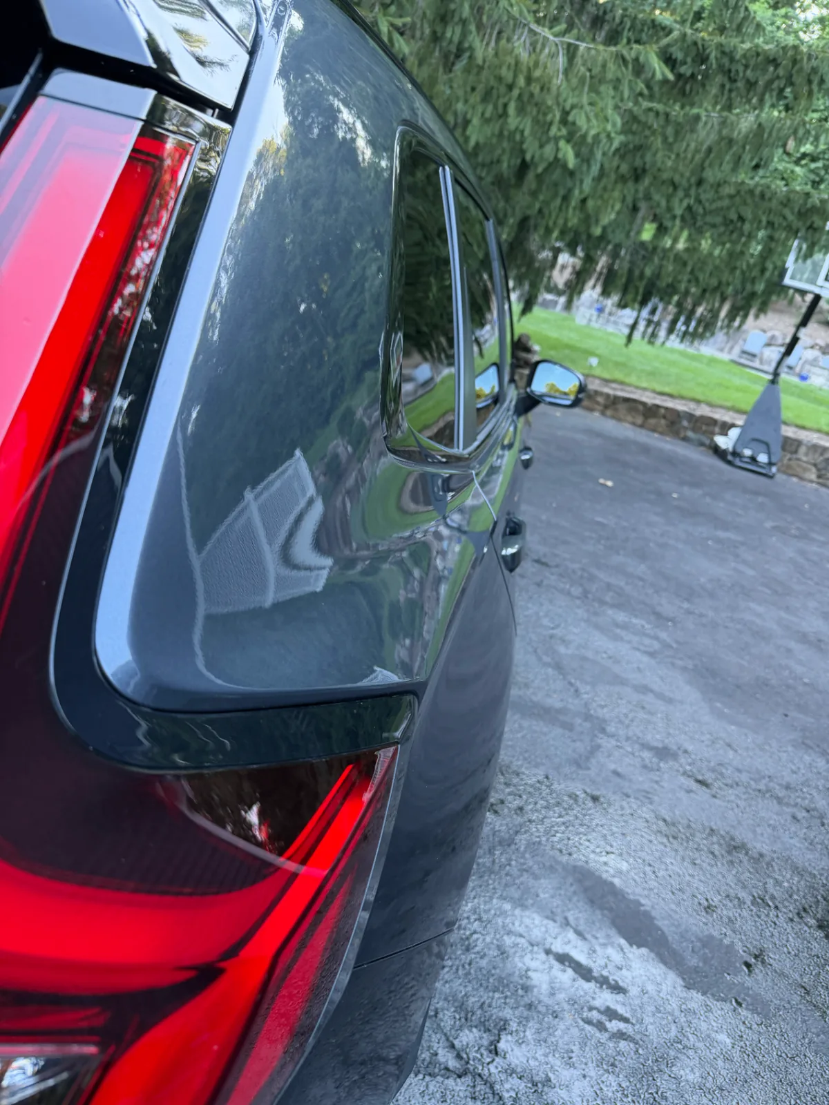 Clean, glossy rear exterior of the same dark grey SUV after Bluefin detailing
