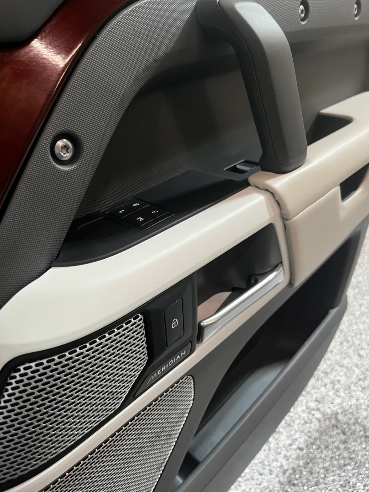 Same door panel with clean armrest and restored trim after Bluefin detailing
