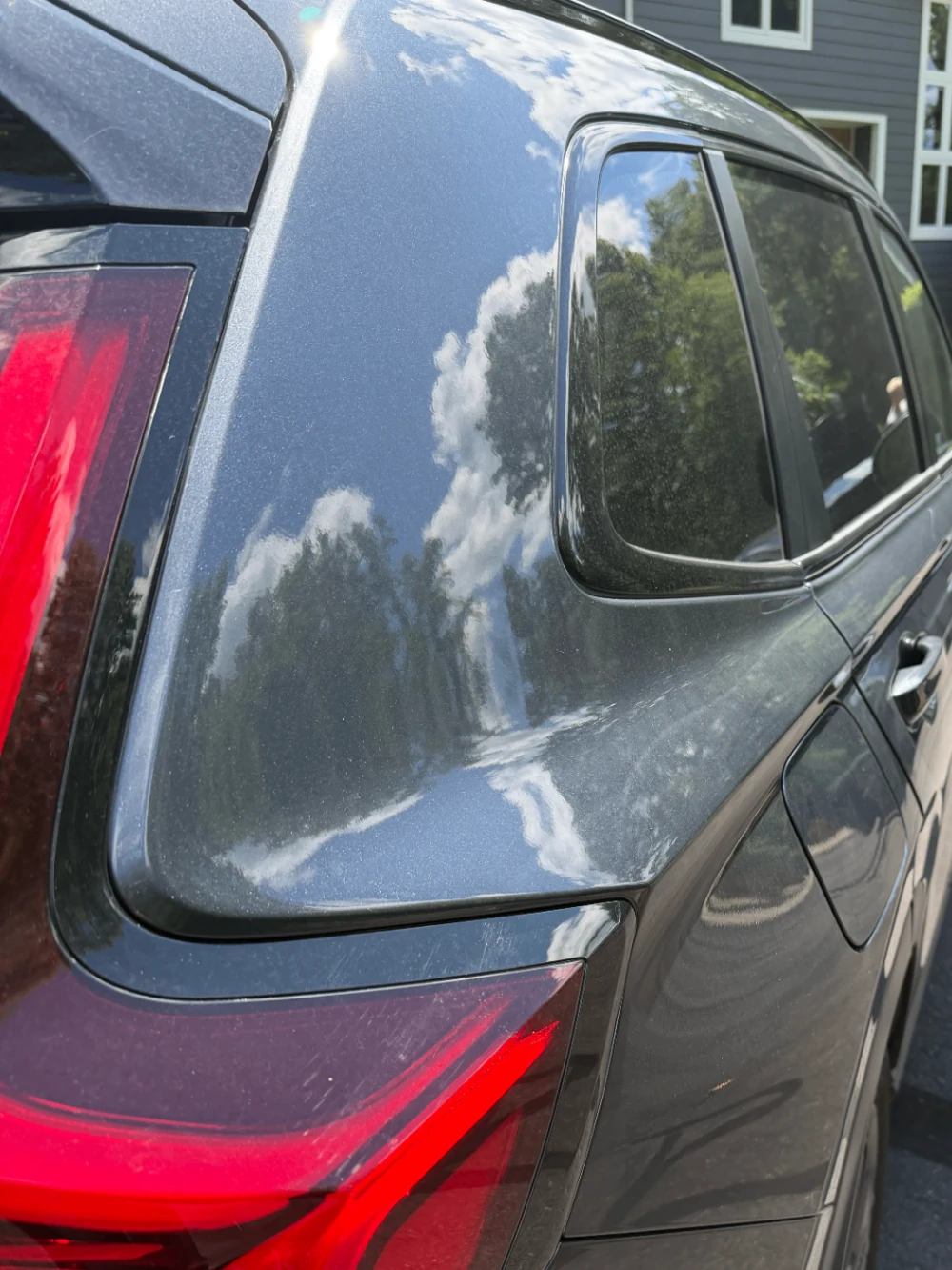 Dusty rear exterior of a dark grey SUV before Bluefin detailing